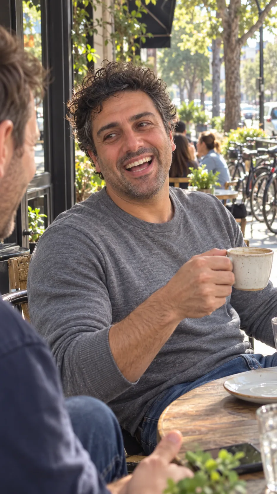 AI-generated example of a future self: a man smiling over a cup of coffee at an outdoor café table.